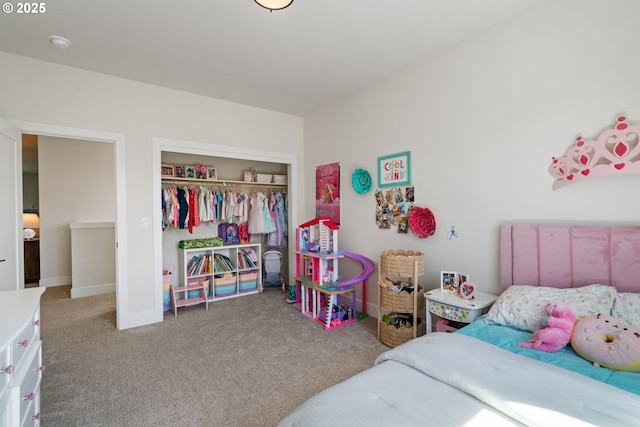 carpeted bedroom with a closet and baseboards
