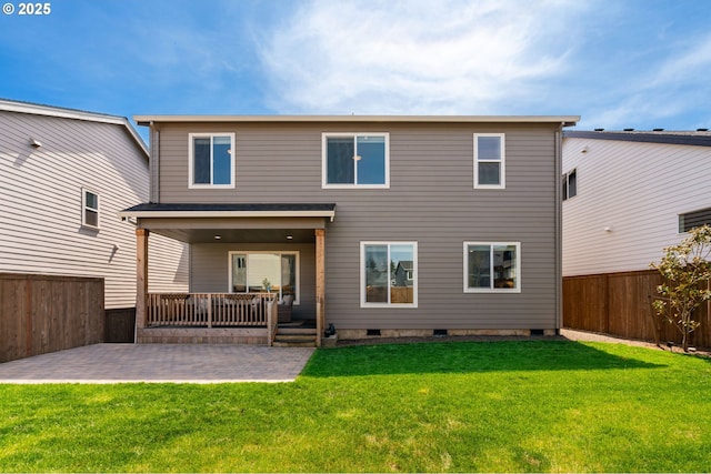 back of house featuring a lawn, a fenced backyard, a patio area, and crawl space