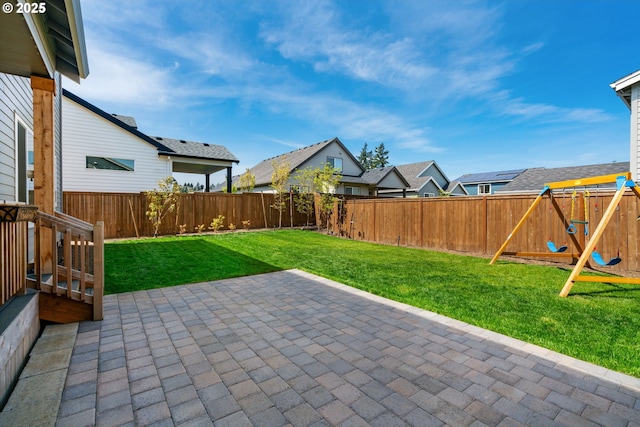 view of patio with a residential view, a fenced backyard, and a playground