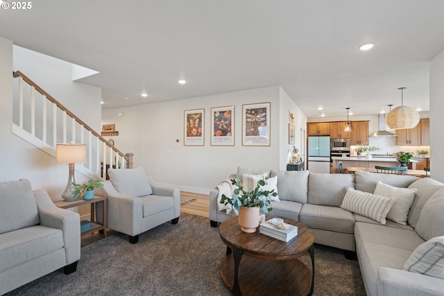 living area with recessed lighting, baseboards, and stairway