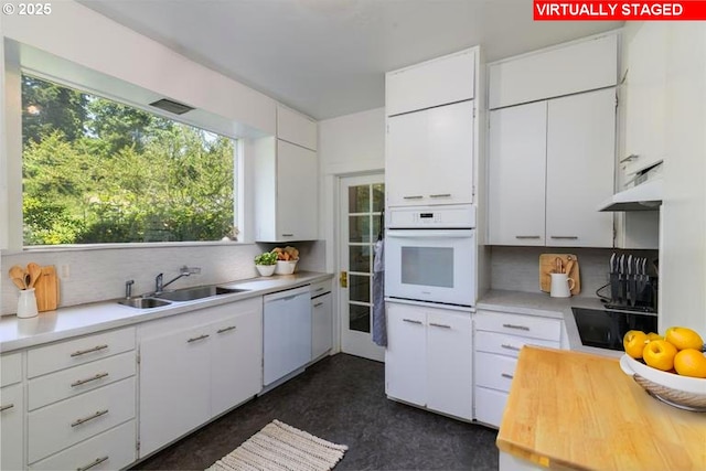 560 N 10th St, Coos Bay, OR 97420 - kitchen with white appliances, light countertops, decorative backsplash, and plenty of natural light