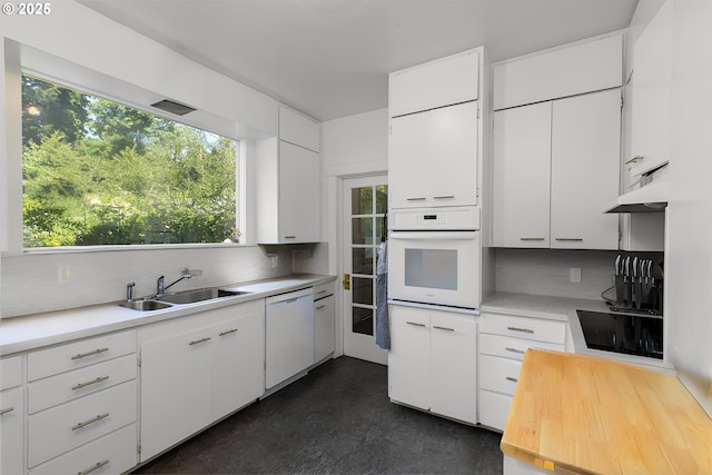 560 N 10th St, Coos Bay, OR 97420 - kitchen with white appliances, decorative backsplash, light countertops, and under cabinet range hood