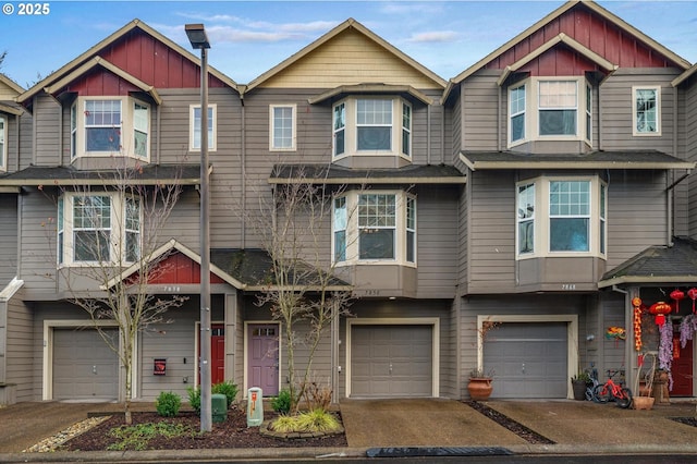 townhome / multi-family property with an attached garage and board and batten siding