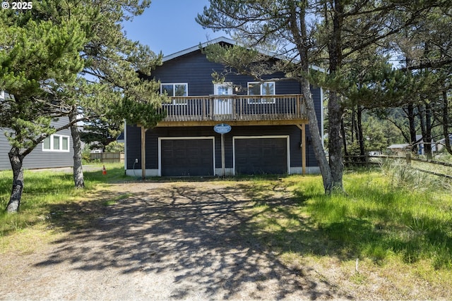 view of front facade featuring an attached garage and dirt driveway