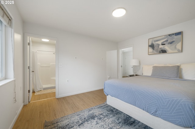 bedroom featuring light wood-style flooring and baseboards