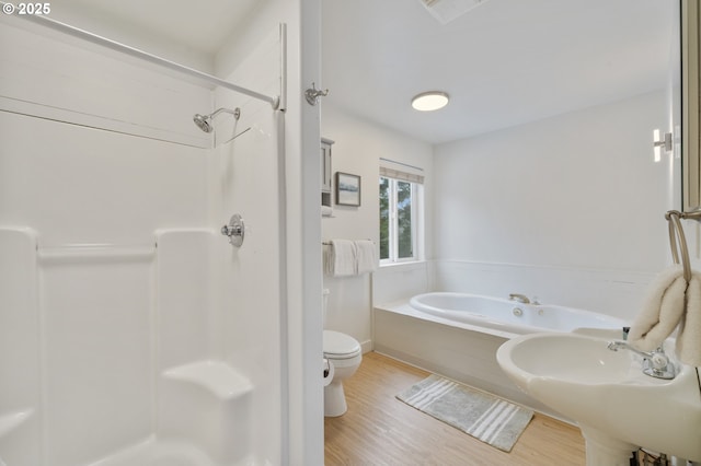 bathroom featuring visible vents, wood finished floors, toilet, and a stall shower