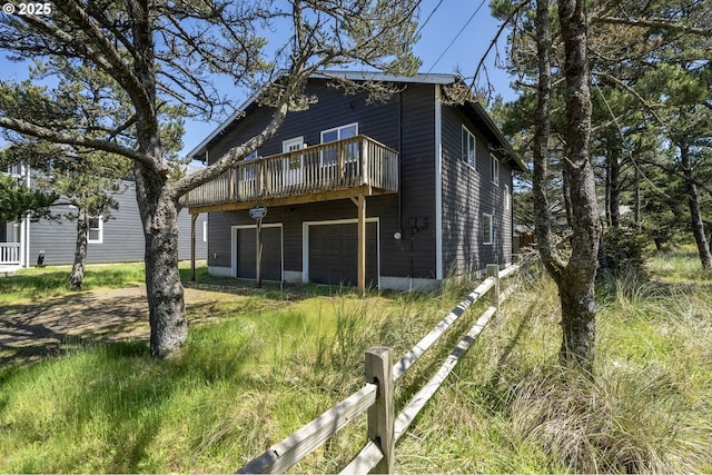 back of house with fence and a garage