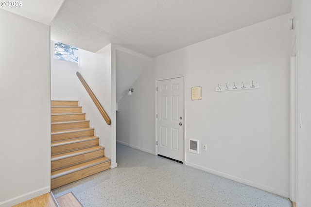 entryway featuring visible vents, stairway, and baseboards