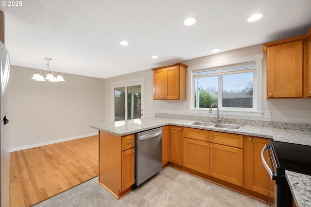 kitchen with sink, stainless steel dishwasher, kitchen peninsula, and light stone countertops