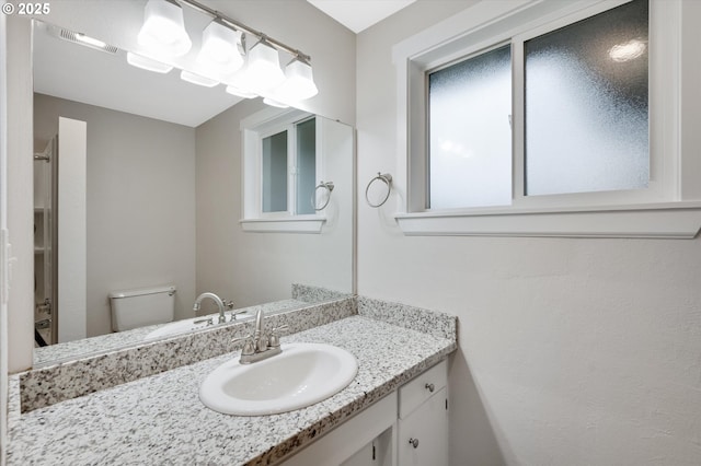 bathroom featuring vanity and toilet