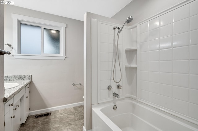 bathroom featuring vanity and tiled shower / bath