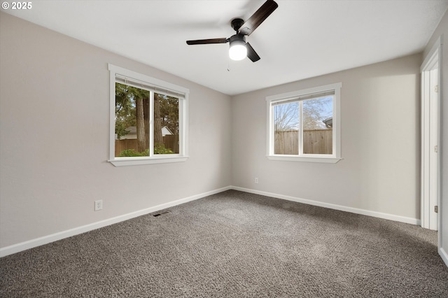 carpeted empty room featuring ceiling fan