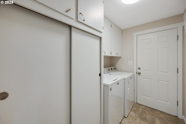 laundry area featuring independent washer and dryer and cabinets