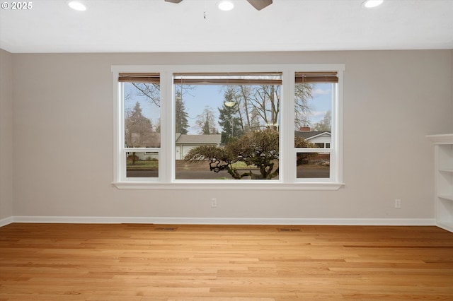 spare room with ceiling fan and light hardwood / wood-style flooring