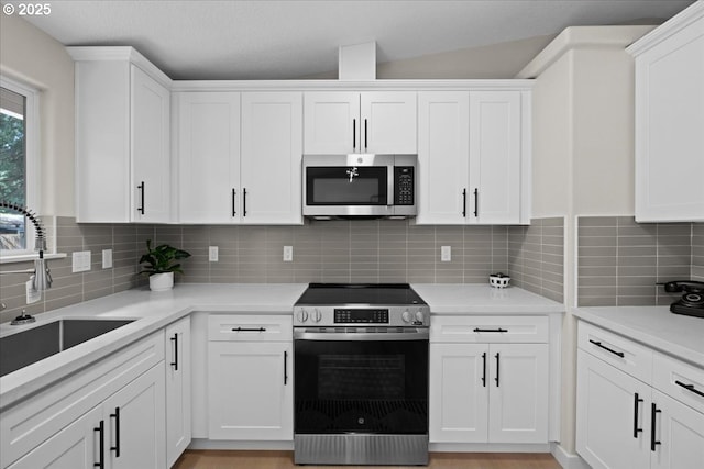 7995 SE Roslyn St, Milwaukie, OR 97222 - kitchen with stainless steel appliances and white cabinets