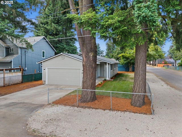 7995 SE Roslyn St, Milwaukie, OR 97222 - view of front of house with concrete driveway, a fenced front yard, and an attached garage