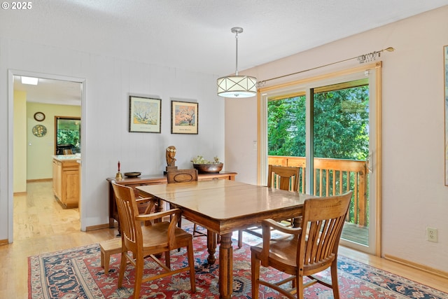 dining space with light wood-style flooring