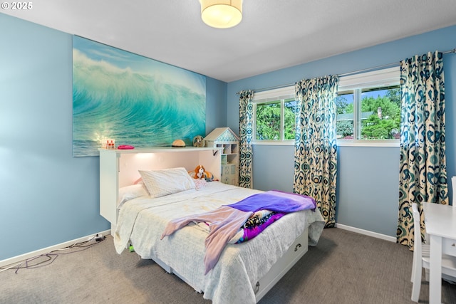 carpeted bedroom featuring baseboards