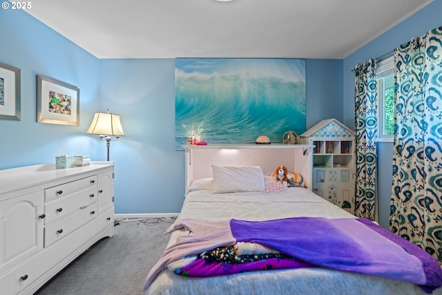bedroom featuring baseboards and carpet