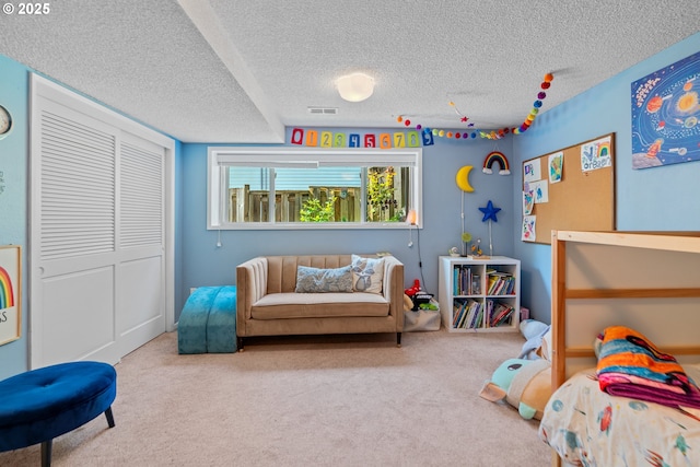 bedroom with carpet flooring, a textured ceiling, and a closet