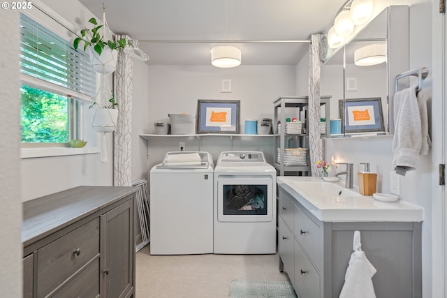 clothes washing area with washing machine and clothes dryer and light floors