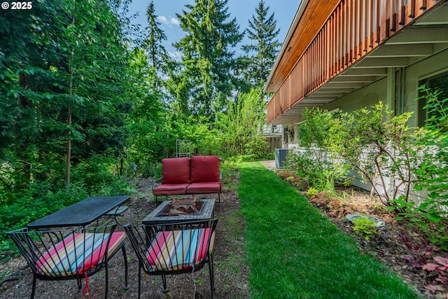 view of yard with a fire pit and a balcony
