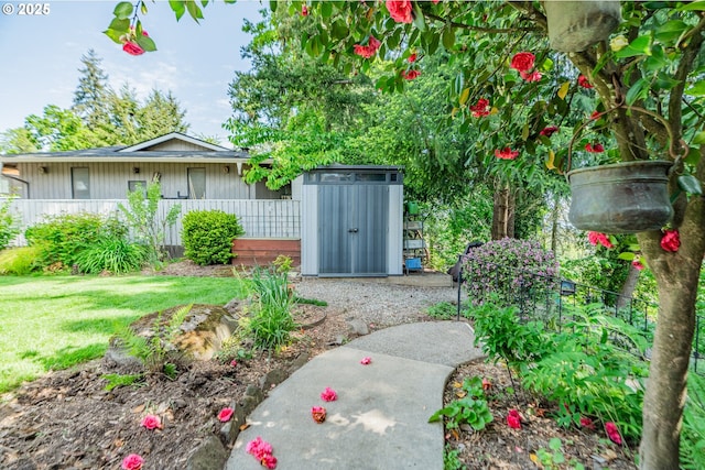 view of yard with fence and a shed