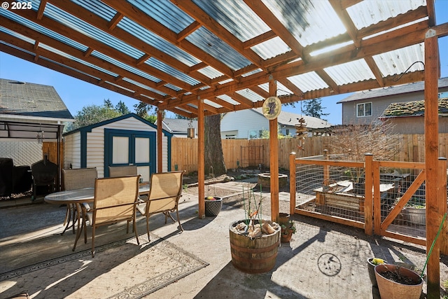 view of patio / terrace with a pergola and a shed