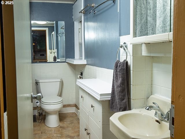 4930 SE 113th Ave, Portland, OR 97266 - bathroom with a sink, toilet, and tile walls