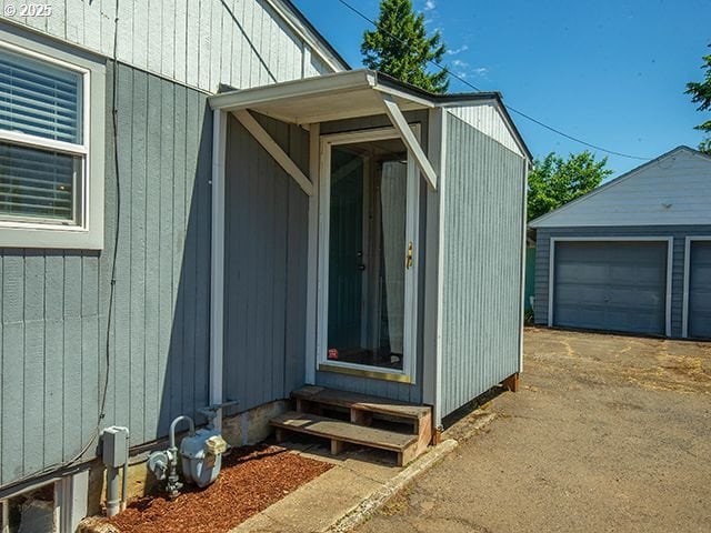 4930 SE 113th Ave, Portland, OR 97266 - view of property exterior with entry steps, an outbuilding, and a detached garage