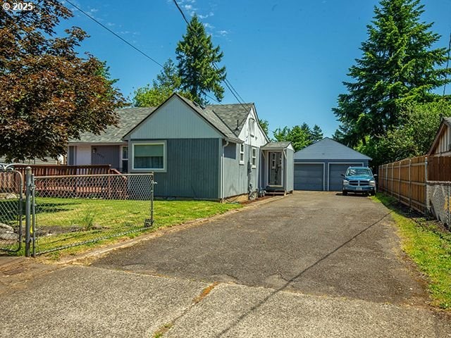 4930 SE 113th Ave, Portland, OR 97266 - view of side of home with a detached garage and an outbuilding