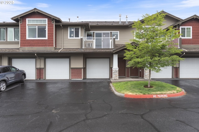 1874 NE 101st Ave Unit 202, Hillsboro, OR 97006 - townhome / multi-family property with a balcony, an attached garage, driveway, and roof with shingles