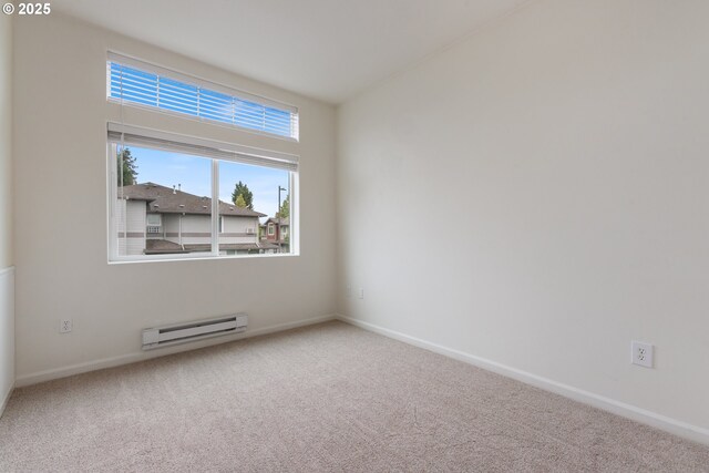 1874 NE 101st Ave Unit 202, Hillsboro, OR 97006 - spare room featuring baseboard heating, carpet, and baseboards
