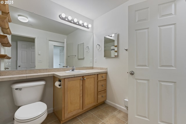 1874 NE 101st Ave Unit 202, Hillsboro, OR 97006 - bathroom featuring toilet, baseboards, vanity, and tile patterned flooring