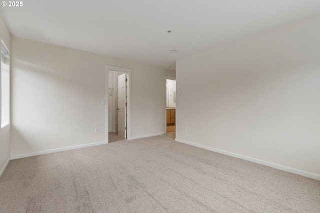 1874 NE 101st Ave Unit 202, Hillsboro, OR 97006 - spare room featuring light carpet and baseboards