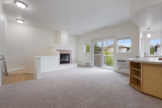 1874 NE 101st Ave Unit 202, Hillsboro, OR 97006 - unfurnished living room with plenty of natural light, light carpet, a fireplace, and a wall unit AC