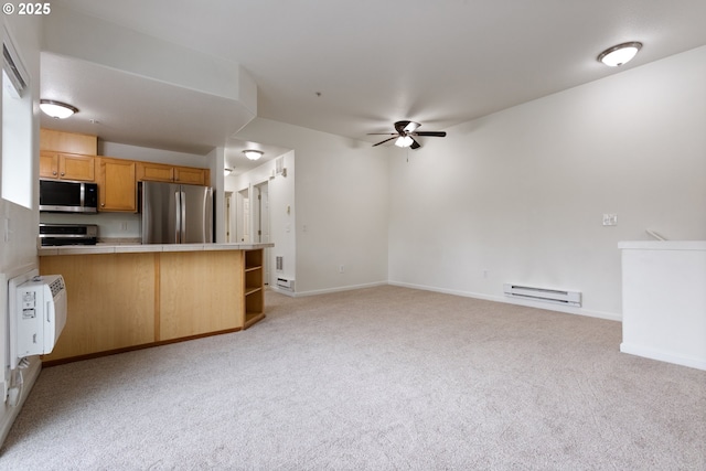 1874 NE 101st Ave Unit 202, Hillsboro, OR 97006 - kitchen with appliances with stainless steel finishes, a baseboard radiator, tile counters, light colored carpet, and ceiling fan