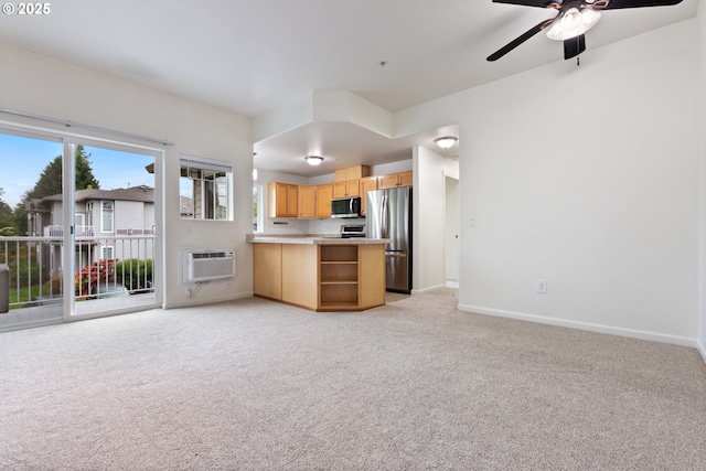 1874 NE 101st Ave Unit 202, Hillsboro, OR 97006 - kitchen with stainless steel appliances, open floor plan, an AC wall unit, a peninsula, and light colored carpet