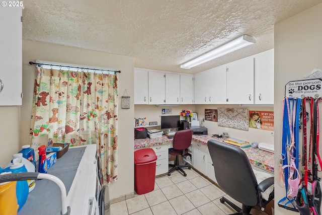 94020 E Shore Dr, North Bend, OR 97459 - home office with a textured ceiling, light tile patterned floors, and built in desk