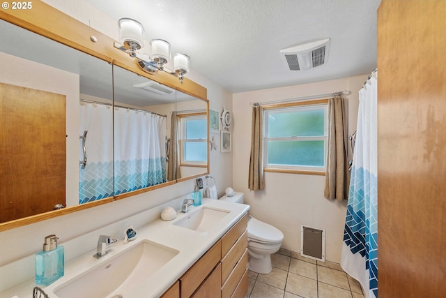 94020 E Shore Dr, North Bend, OR 97459 - bathroom with double vanity, toilet, tile patterned floors, a textured ceiling, and curtained shower