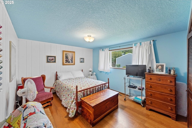 94020 E Shore Dr, North Bend, OR 97459 - bedroom featuring light wood-style flooring and a textured ceiling