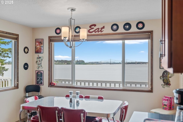 94020 E Shore Dr, North Bend, OR 97459 - dining area with a chandelier and a water view