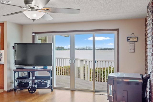 94020 E Shore Dr, North Bend, OR 97459 - living room with wood finished floors, a ceiling fan, and a textured ceiling
