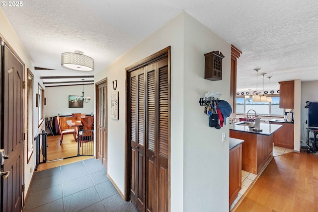 94020 E Shore Dr, North Bend, OR 97459 - hallway featuring a textured ceiling and a sink