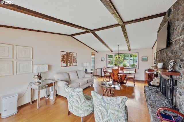 94020 E Shore Dr, North Bend, OR 97459 - living area with light wood-type flooring, a stone fireplace, and baseboards