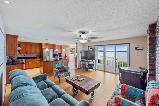 94020 E Shore Dr, North Bend, OR 97459 - living area with ceiling fan, light wood-type flooring, recessed lighting, and a textured ceiling