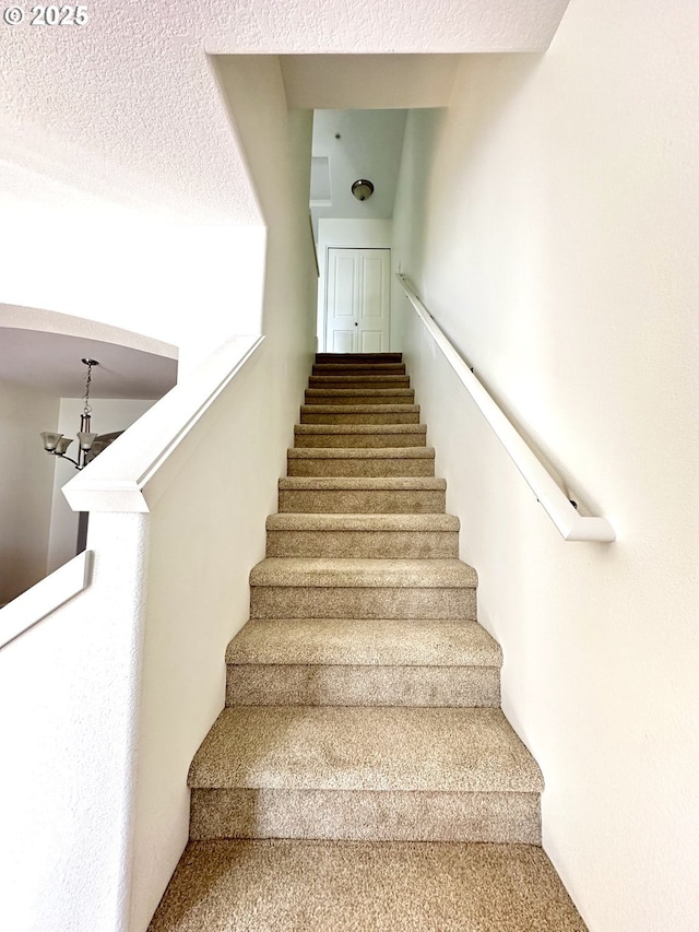 836 NW 118th Ave Unit 104, Portland, OR 97229 - staircase featuring carpet flooring and a chandelier
