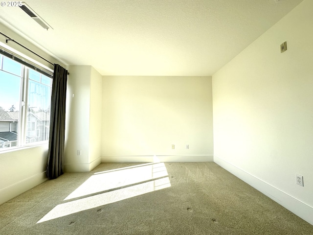 836 NW 118th Ave Unit 104, Portland, OR 97229 - carpeted spare room featuring a textured ceiling and baseboards