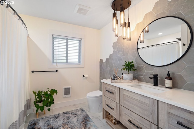 full bath with toilet, vanity, tile walls, baseboards, and marble finish floor