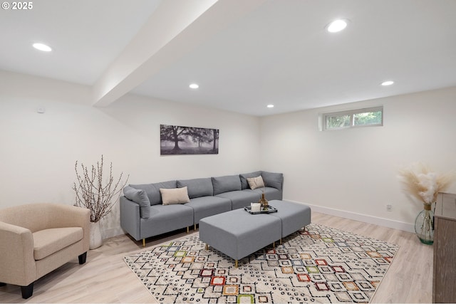 living area with light wood-style floors, baseboards, and recessed lighting